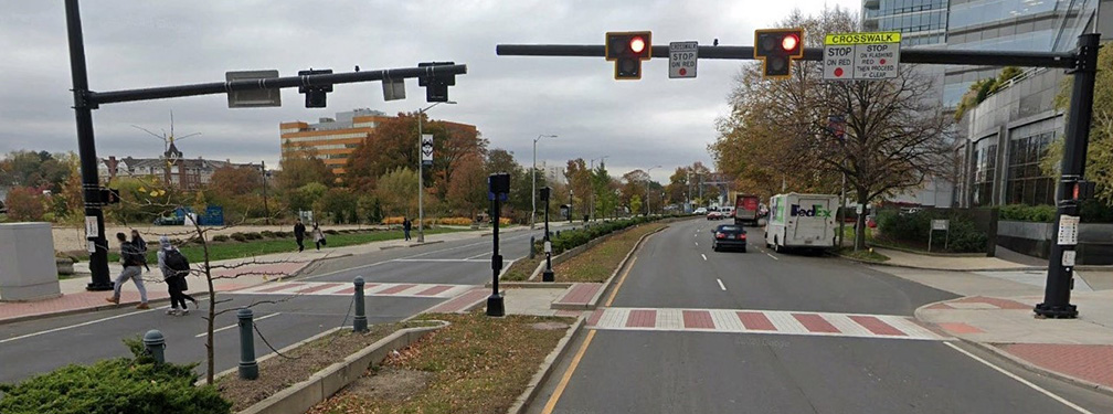 Striped crosswalk at a stoplight.