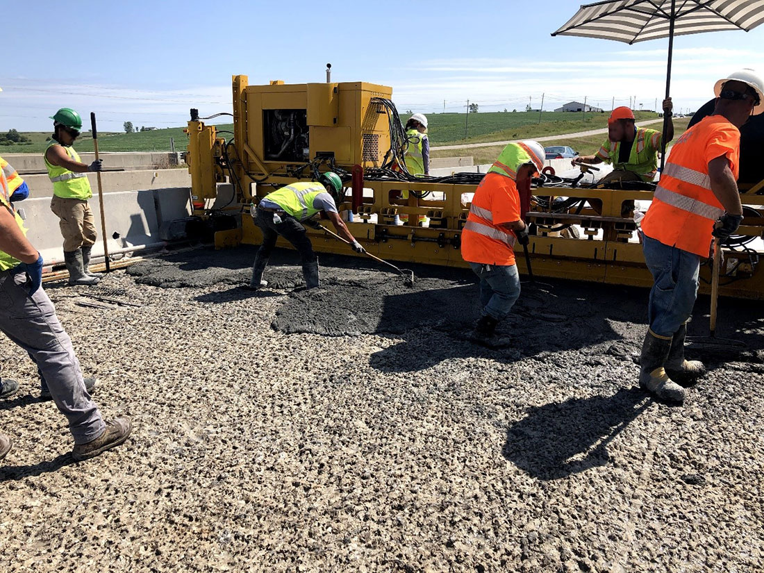 Work crew spreading UHPC