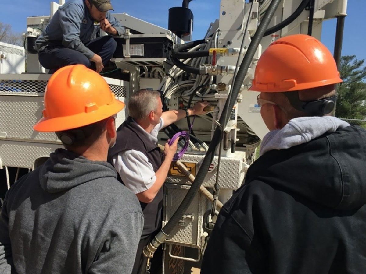 Illinois DOT Drill Crew and Engineers discuss location for hydraulic sensor on IDOT drill rig. (Credit IDOT)