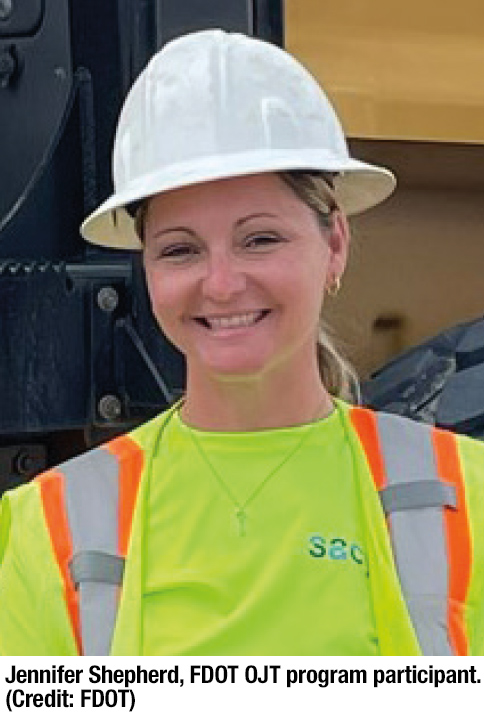 Woman, wearing hard hat and safety vest