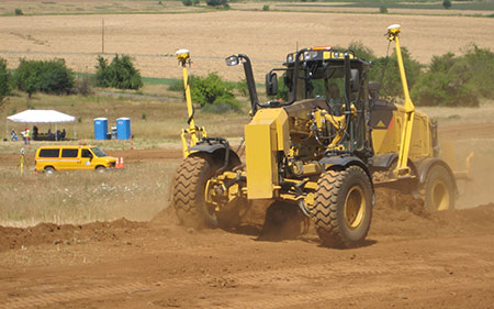 Motor grader equipped with GPS and onboard computer uses 3D surface model for automated machine guidance