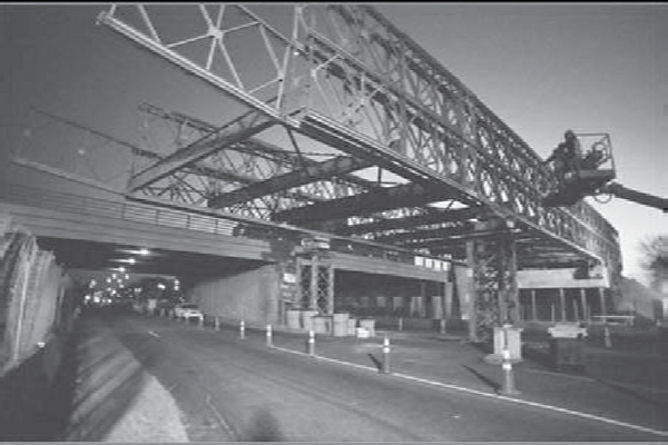 Black and white photograph of a temporary bridge built next to the old bridge helped keep traffic moving during a New York City DOT reconstruction project. Photo credit: Gannett Fleming Engineers and Architects.