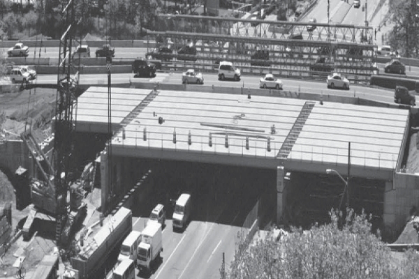 Black and white photograph showing precast cap beams were among the prefabrcated elements used to save time on the new york city dot project. Credit: Gannett Fleming Engineers and Architects