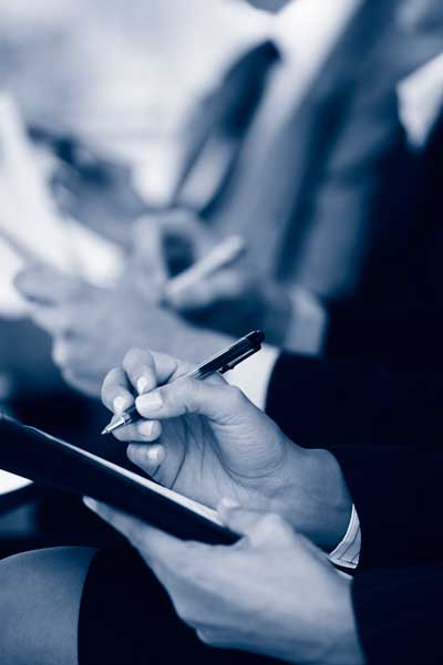 Photograph showing a person taking notes in a training course.