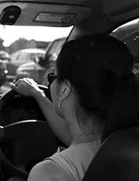 Photograph of a driver at the wheel in traffic