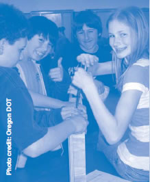 Photograph of four Reedsport middle school students building bat boxes.