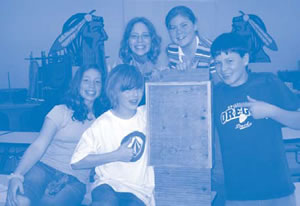 Photograph of Reedsport middle school students holding their finished bat boxes.