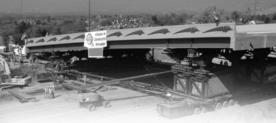 This photograph shows the prefabricated bridge section being moved into its new location on the Utah Highways for LIFE project. A post-construction survey showed that customers were pleased with the construction approach and final product.