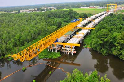 A gantry used to build a bridge in an environmentally sensitive area drove piles, placed pier caps and positioned girders.