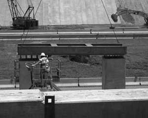 Worker on the Georgia Highways for LIFE project uses a template to check the alignment of prefabricated bridge columns.