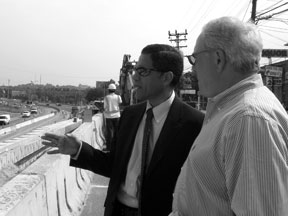 FHWA Administrator Victor Mendez (left) and Butch Marcelle of Fort Miller Co. check progress on a Washington, D.C., bridge project using prefabricated components to speed construction and reduce traffic impact.