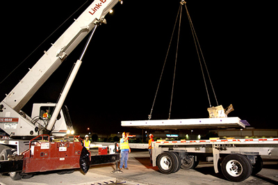 Photo Caption 1: Participants in a Highways for LIFE  showcase in California watched the nighttime installation of precast concrete  pavement panels.