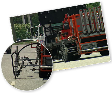 The automated pavement marker placement system fits on a truck and uses a computer controlled robotic arm to install markers more safely than manual methods. Photo Credit: Stay Alert Safety Services.