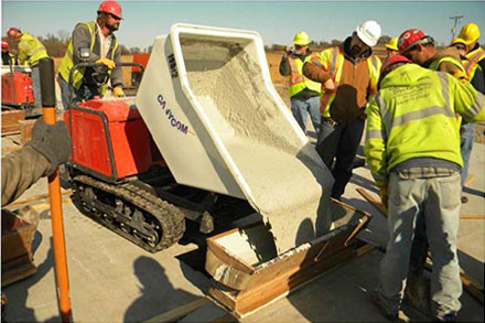 Photo of workers poured ultra-high-performance concrete in the joints between the modular superstructure units.