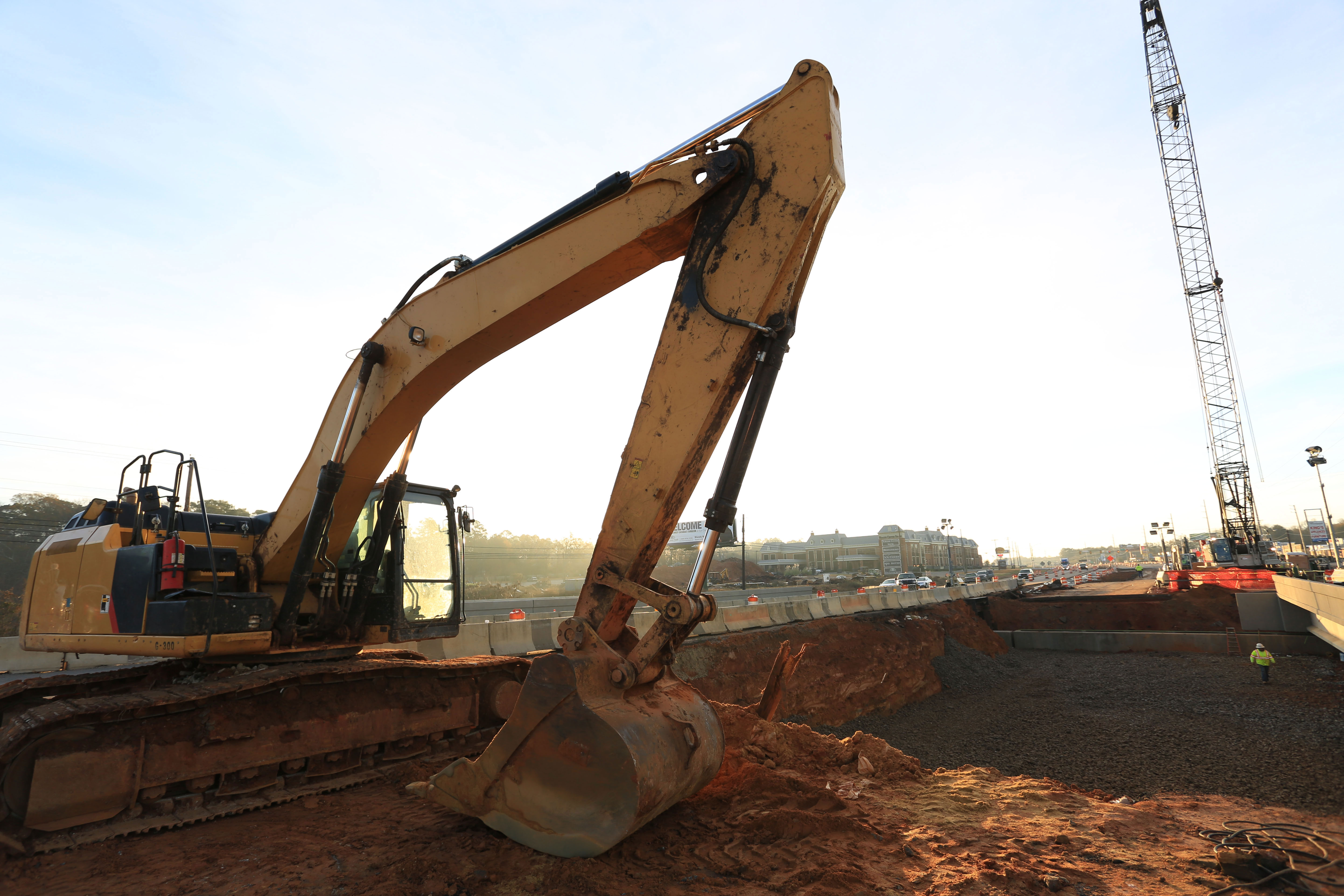 Workers excavate dirt in preparation for the Dothan, Alabama, bridge slide.