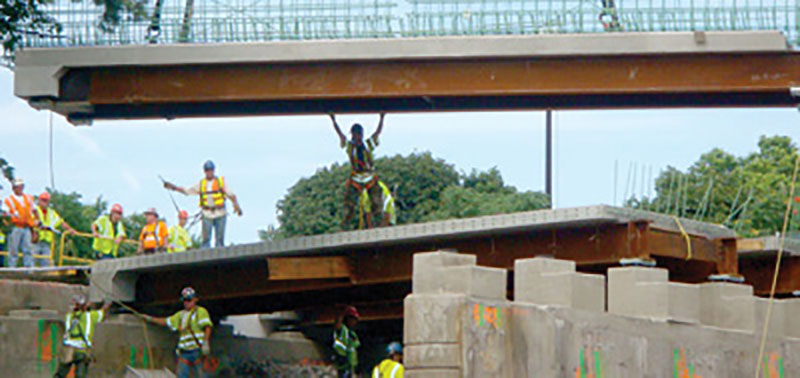 Photo of construction crews moving a bridge superstructure into place on a Massachusetts bridge project.