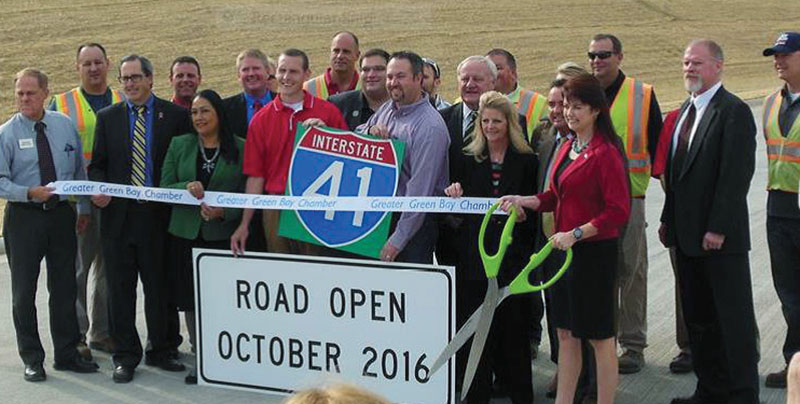 Photo of transportation officials preparing to cut a ribbon to open an I-41 interchange in Wisconsin.