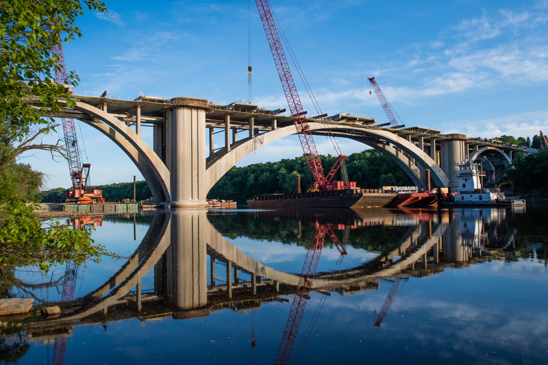 Photo of floating cranes next to the Franklin Avenue Bridge over the Mississippi River in Minneapolis, MN.