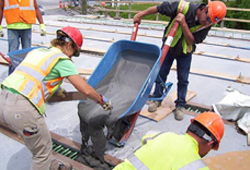 Photo of workers pouring a UHPC connection.