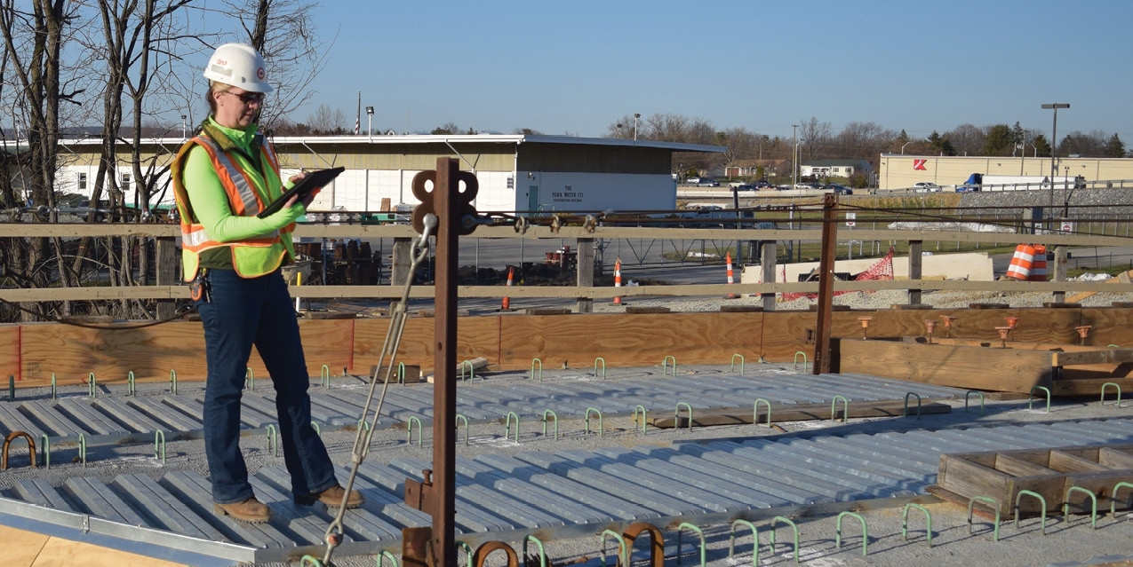 Photo of project team member with electronic device at a jobsite