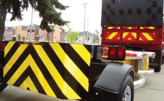 Photo of dump truck affixed with a crash attenuator.