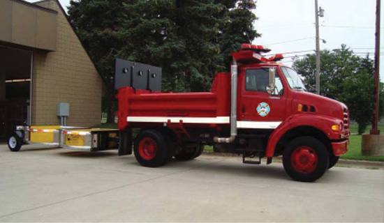 Photo of dump truck affixed with a crash attenuator.