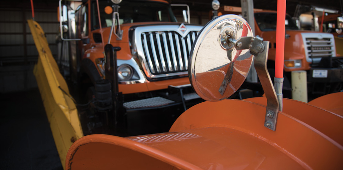 Photos of snowplow with mirror mounted on plow.