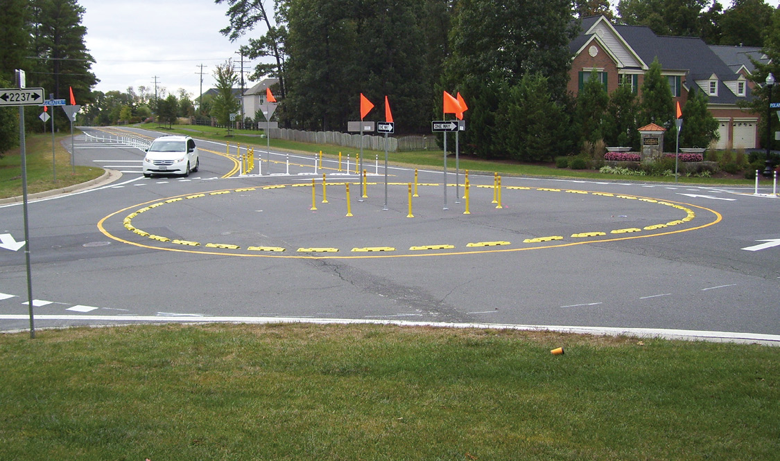Photo of car traveling on roundabout made with off-the-shelf materials.