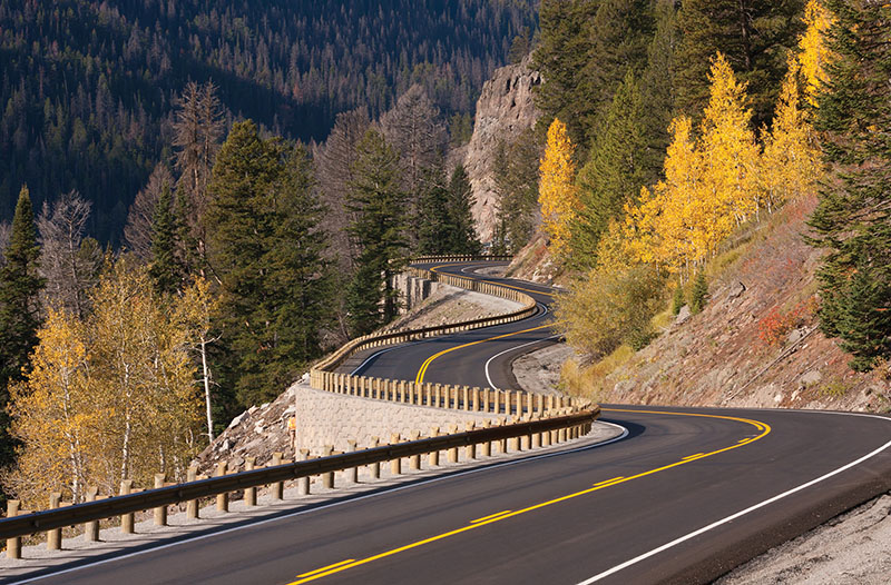 Photo of road winding through wooded landscape.