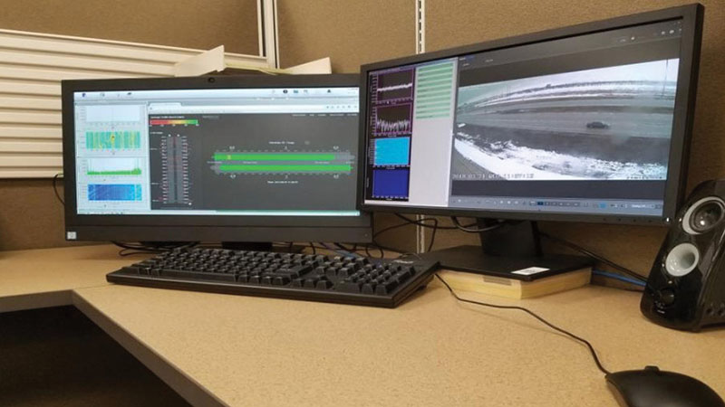 Photo of desktop computer system and monitors displaying traffic monitoring information.
