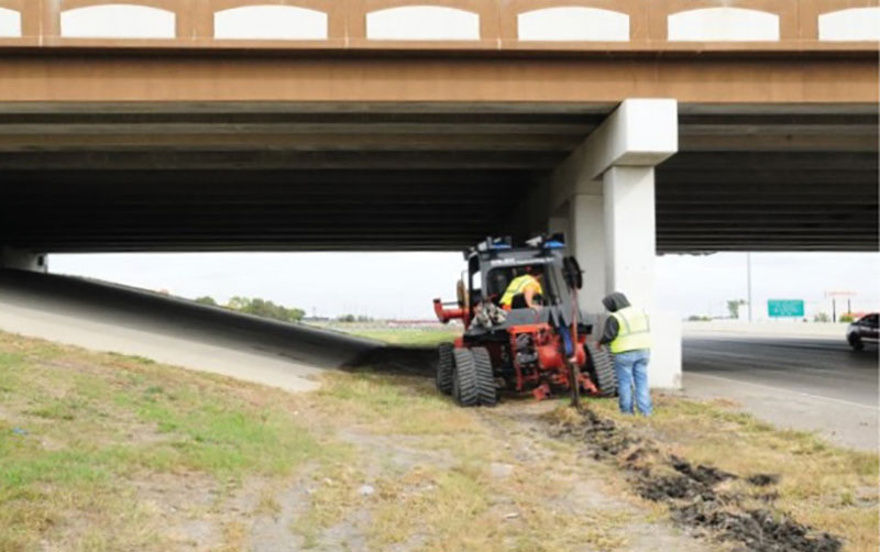 Photo of work crew installing fiber at roadside.