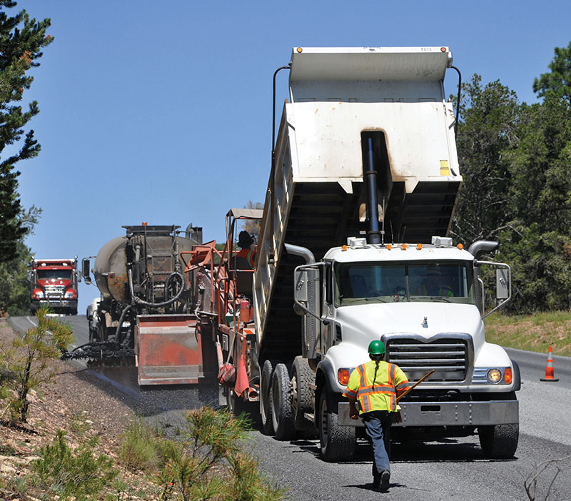 Photo of work crew and paving equipment on a road project.