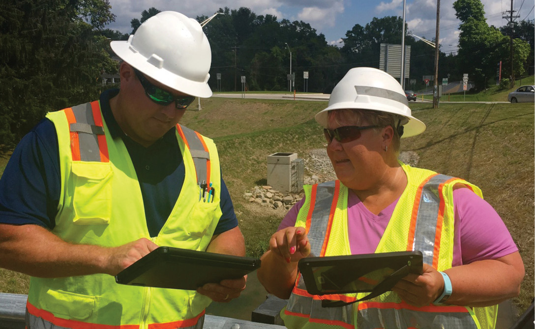 two road workers collaborating