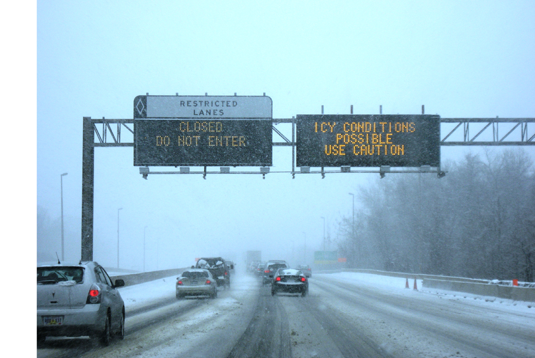 Snowy roadway with traffic control signs
