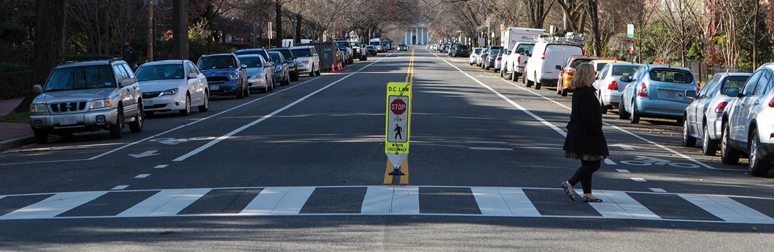 Photo of woman on crosswalk with visibility enhancements.