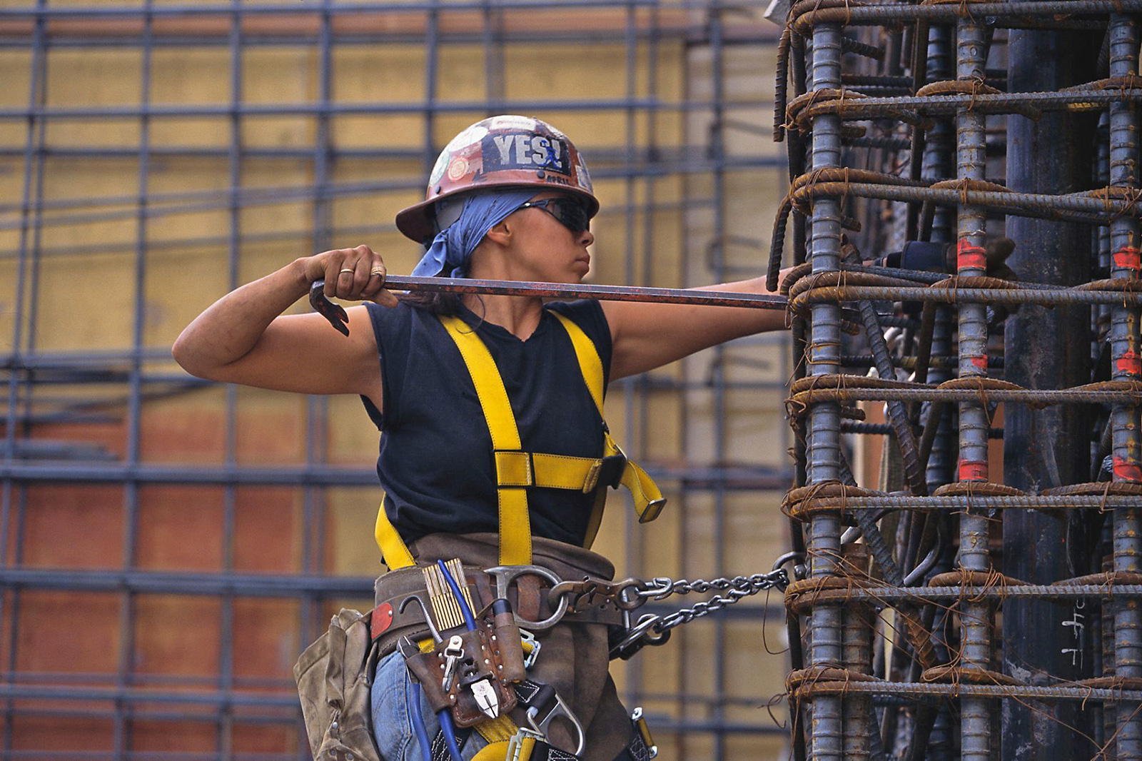 Female construction worker working with rebar.