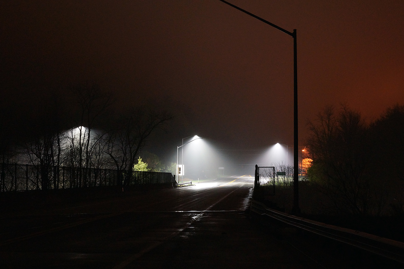 Night photograph of enhanced lighting on a rural intersection.