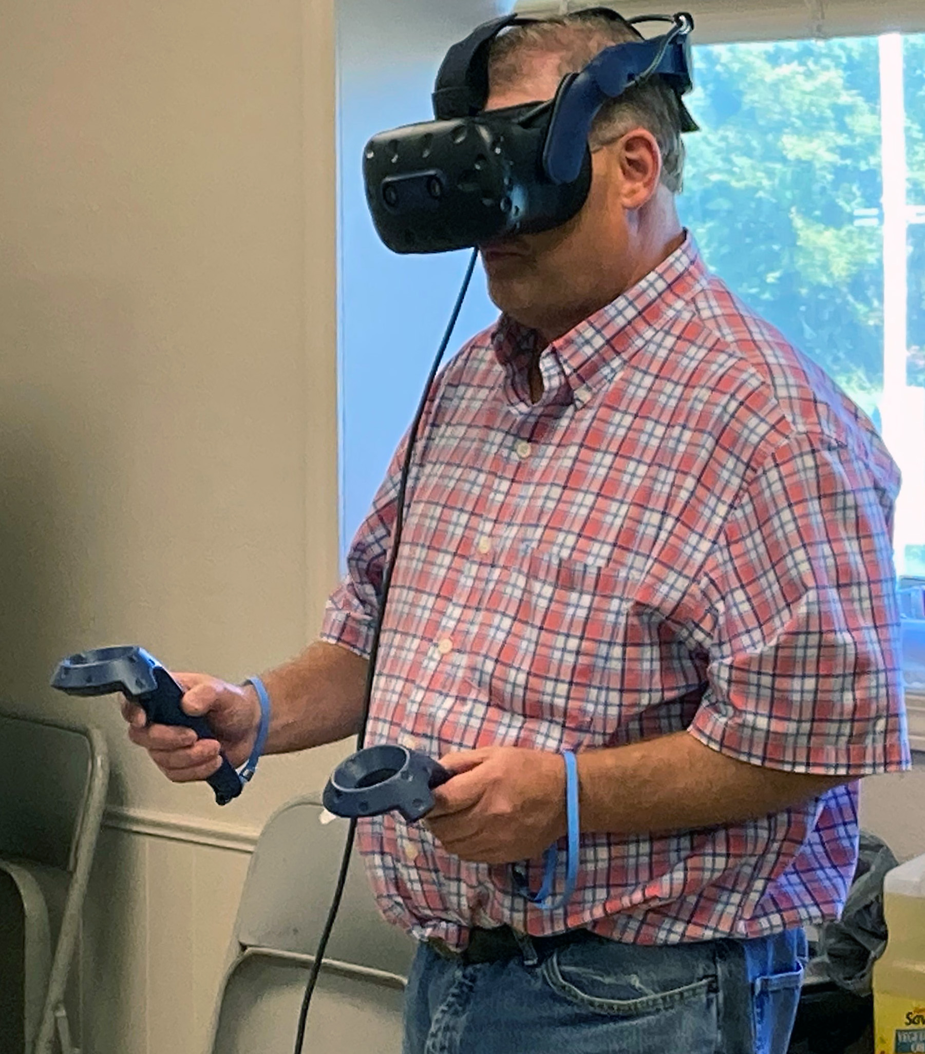 Person wearing and testing virtual reality gear.