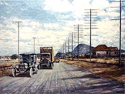 A car and truck travel down a wide country road.