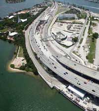 Overhead daytime view of traffic driving over a bridge