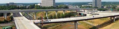 Photo. Daytime panoramic view of several highways and an overpass.