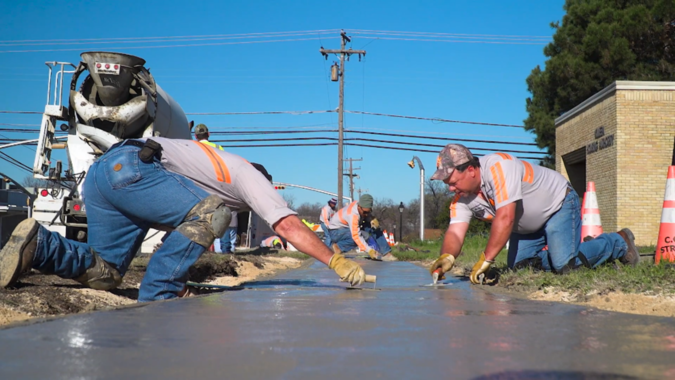 Construction workers laying concrete