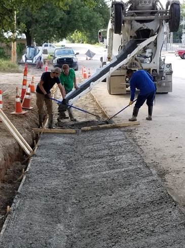 Construction workers performing road improvements in the City of Hamilton.