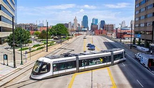 A Omaha Modern light rail cross over street in Omaha downtown surrounding high buidings