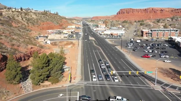 Intersection at stop light with Utah mountains in background.