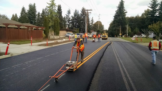 Construction workers performing restriping on a City of Marysville Street.