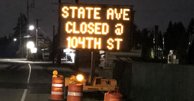 Sign warning drivers of the upcoming closure at 104th Street of State Avenue north of 100th Street extending to complete the next phase of construction.