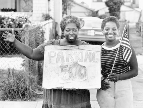 Ladies holding a parking sign