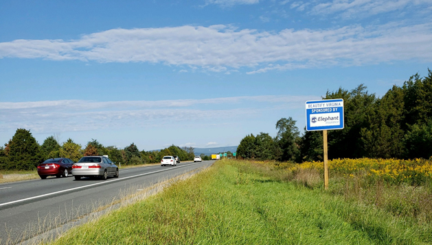 Road with cars with sign for Beautify Virginia