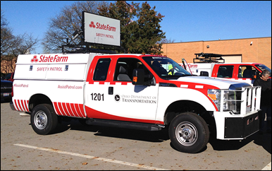 Truck outfitted for safety patrol use with red-and-white State Farm branding all over the truck and on a sign on trop of the truck  and an inobtrusive Ohio DOT insignia on the cab door.